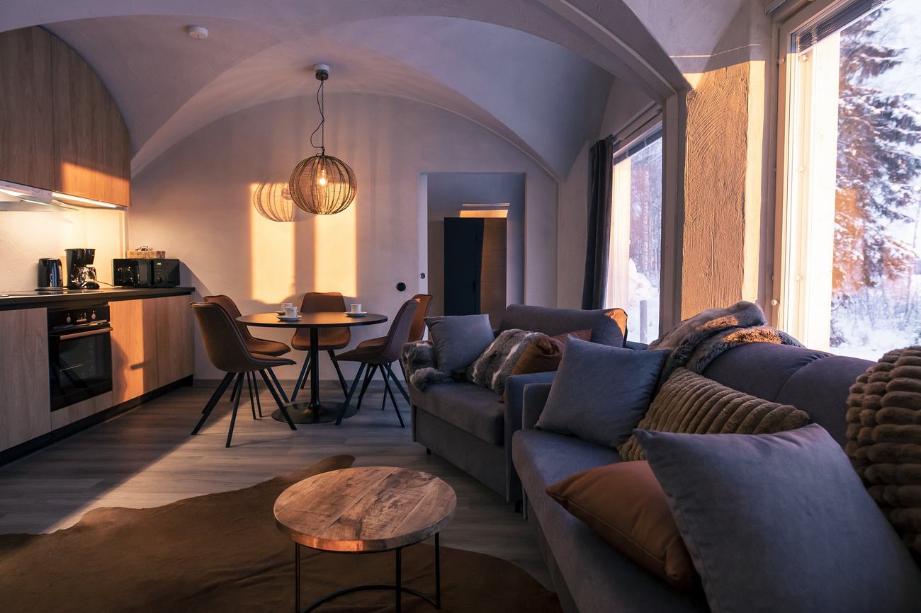 Open-plan vaulted living space with kitchen, dining area and picture window