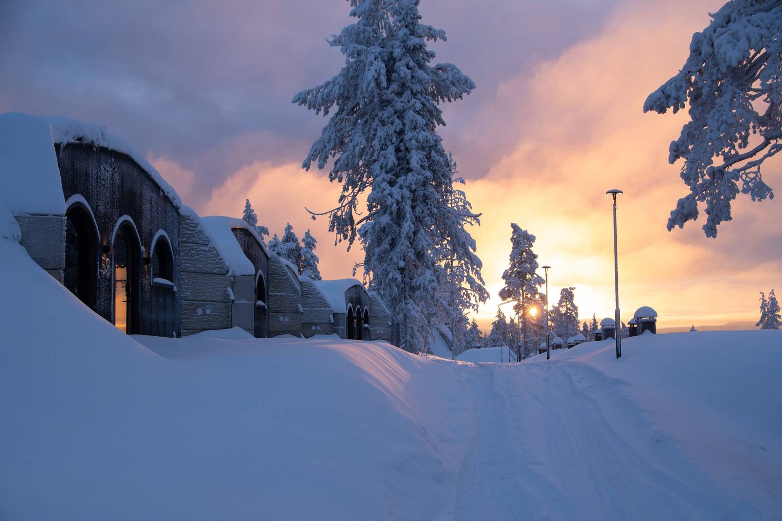 Arched earth-sheltered suites under deep snow at sunset