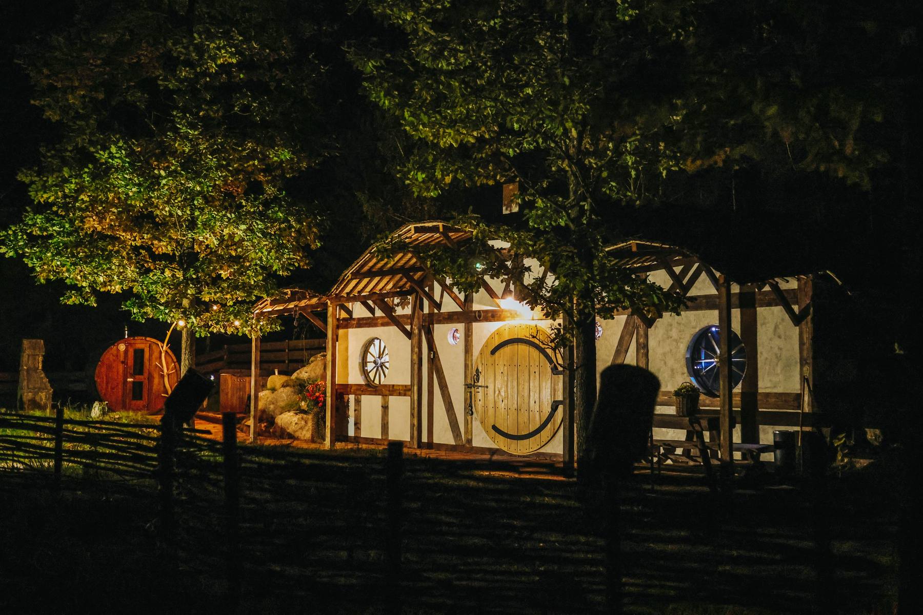 Hobbit-style glamping houses glowing at night