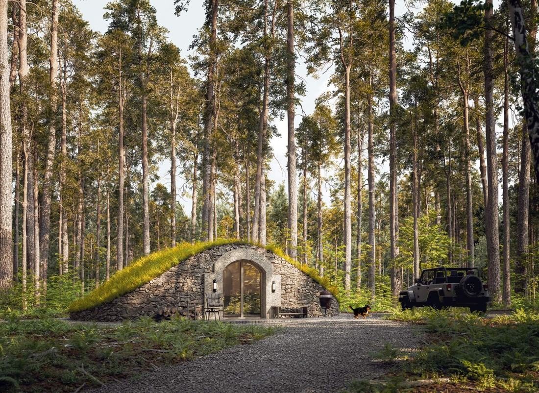 Modular 10 garden pod: stone-clad earth-sheltered pod with living roof in a forest clearing